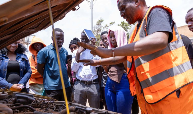 Driving students learning basic mechanics during their driving lessons in Bugolobi, Kampala